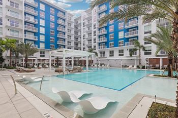 Heated zero-edge saltwater pool with sundeck, cabanas, fire pits and water feature